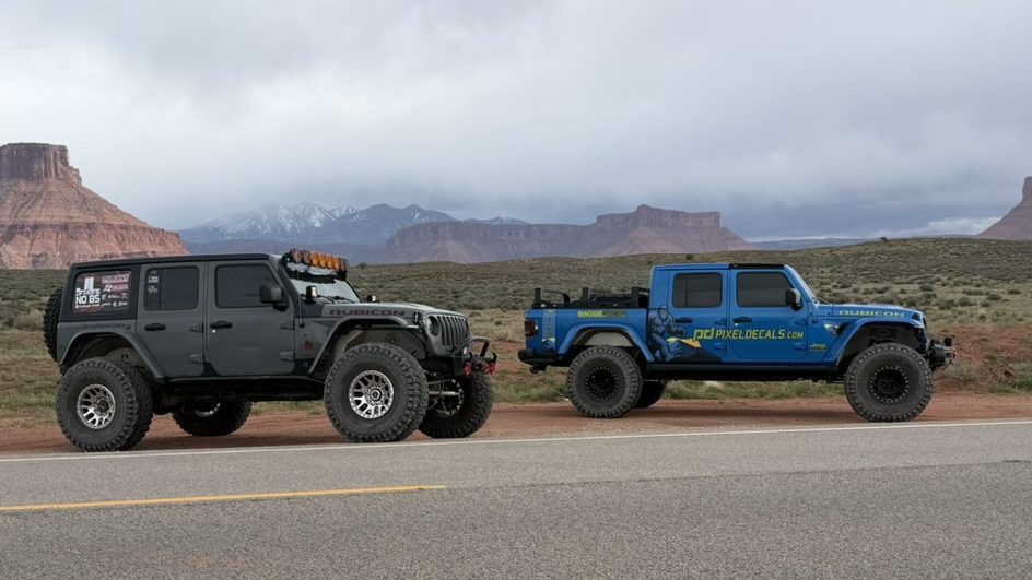 Jeeps lined up in front of red-rock mesas at Easter Jeep Safari 2026 in Moab